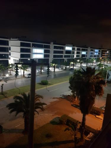 a view of a city street at night with a building at Résidence les florianes in Mohammedia