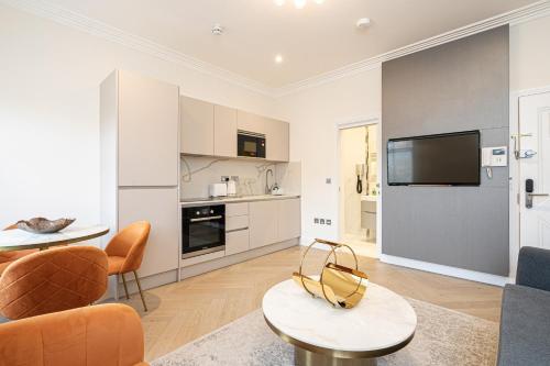 a living room with a couch and a table at Modern Apartments Near Harrods and the Science Museum in London