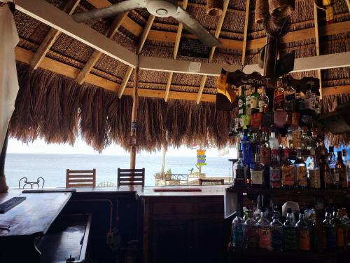 a bar in a restaurant with a view of the ocean at Ltu Garden in Negril