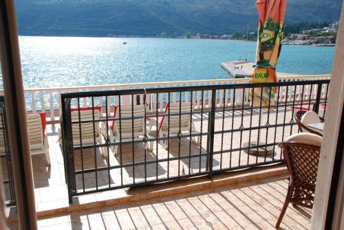 a balcony with a view of a beach and the water at Apartments Sun House in Herceg-Novi