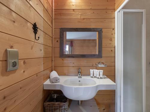a bathroom with a white sink and a mirror at Chalet de charme à Saint Marcel, 4 chambres, 10 pers, proche navette ski, label 5 flocons Or - FR-1-570-18 in Saint-Marcel