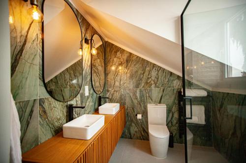 a bathroom with a sink and a toilet and a shower at Storytellers Palace in São Martinho do Porto