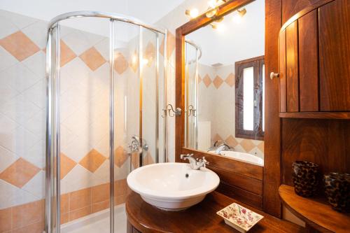 a bathroom with a sink and a glass shower at Maisonette in Roussa Ekklisia in Sitia