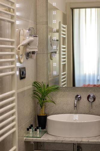 a bathroom with a sink and a mirror at Cinque Terre Gateway in La Spezia