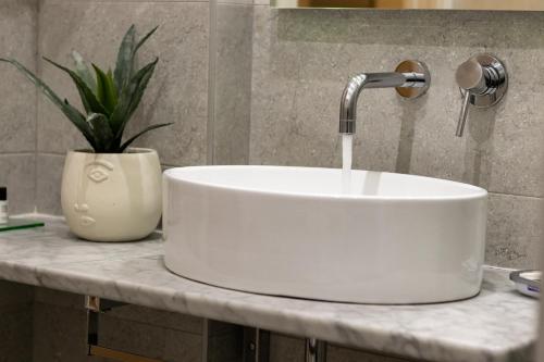 a white sink on a counter in a bathroom at Cinque Terre Gateway in La Spezia