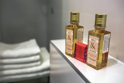 two bottles of essential oils sitting on a table at Grisogono Palace Heritage Residence in Split