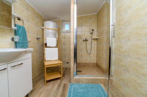 a bathroom with a shower and a sink at Krcina Holiday Home in Cres