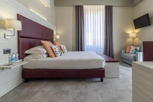 a hotel room with a large bed and a couch at Cinque Terre Gateway in La Spezia