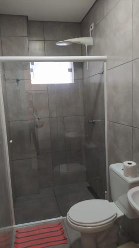 a bathroom with a shower with a toilet and a sink at Hotel Itu Shopping in Itu