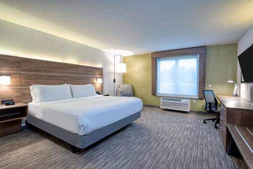 a hotel room with a large bed and a desk at Holiday Inn Express Radcliff Fort Knox by IHG in Radcliff