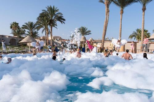 people playing in a cloud pool at a resort at Parrotel Aqua Park Resort in Sharm El Sheikh