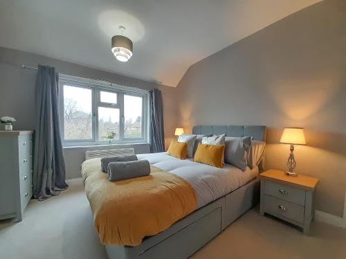 a bedroom with a large bed and a window at New Marston Apartment in Oxford