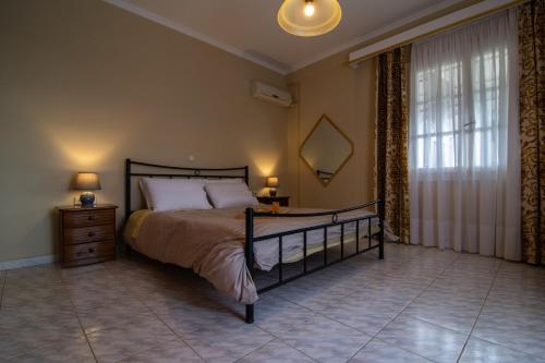 a bedroom with a bed and a large window at Nikolas apartment II in Nafplio