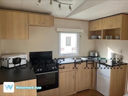 a kitchen with black and white decorations on the counters at Caravan Holiday on Haven site in Cleethorpes