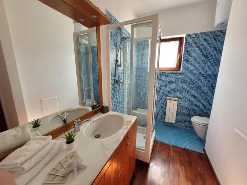 a bathroom with a sink and a shower and a toilet at Sara blu apartment in Sorrento