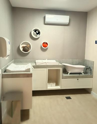 a bathroom with a sink and a toilet in it at Aqualand Park & Resort Oficial in Salinópolis