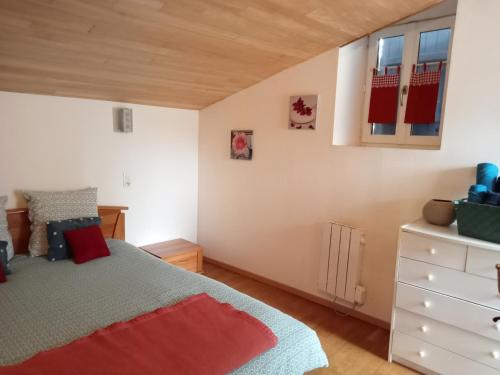 a bedroom with a bed and a dresser at La maison neuve in Fontaines