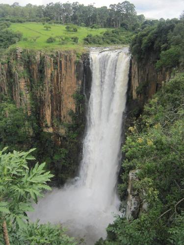 a waterfall on the side of a mountain at Meander In in Howick