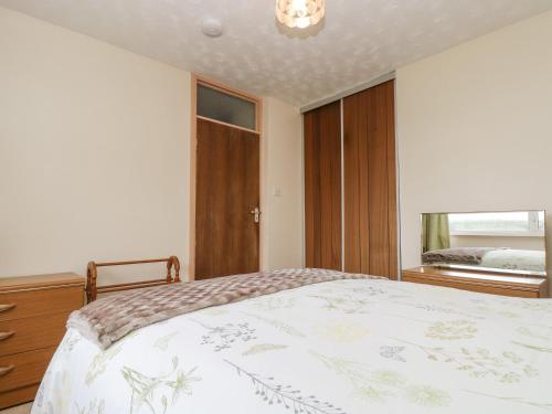 a bedroom with a bed and a window at Underlanes in Camelford