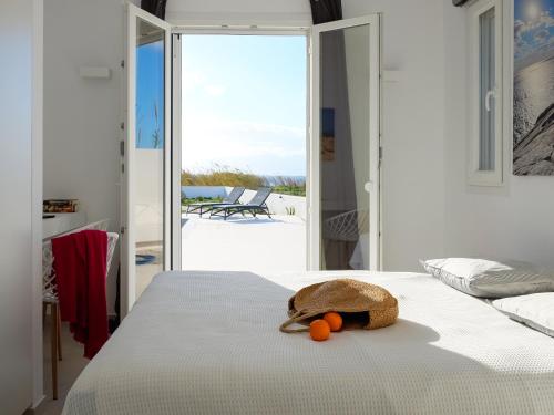 a stuffed animal sitting on a bed in a bedroom at Villa Aura in Kastraki Naxou