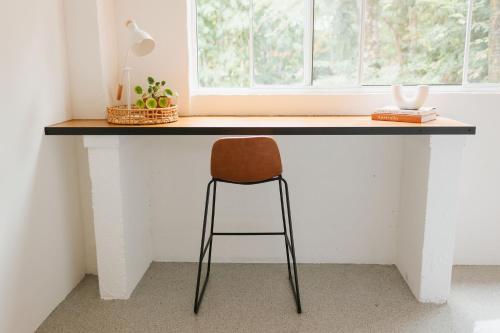 a desk with a chair in front of a window at Tinarra Treetops in Maroochy River