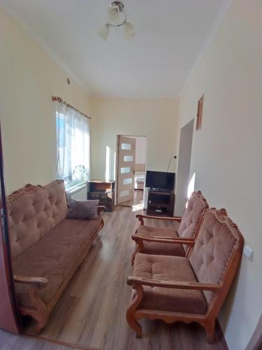 a living room with two couches and a television at BIG HOUSE in Dilijan