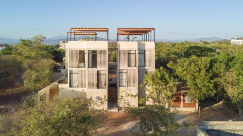 a building on top of a hill with trees at Casa Kame in Puerto Escondido