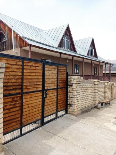 a wooden fence in front of a house at BIG HOUSE in Dilijan