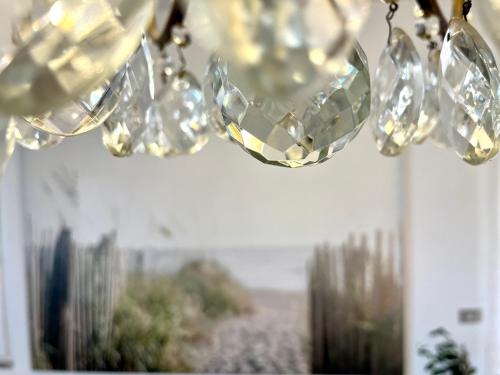 a chandelier with diamonds hanging from the ceiling at Family Apartment 2 Sirmione in Sirmione