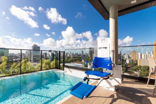 a swimming pool on the roof of a building at TOLIVE One Housi Recife by Carpediem in Recife