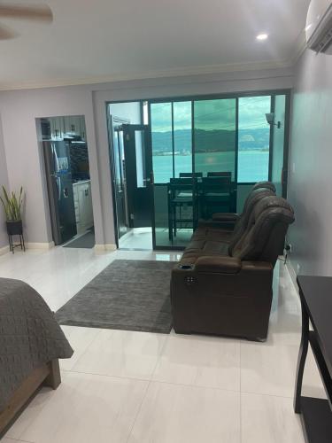 a living room with a brown couch and a table at K&S SEAVIEW luxury apartment in Montego Bay