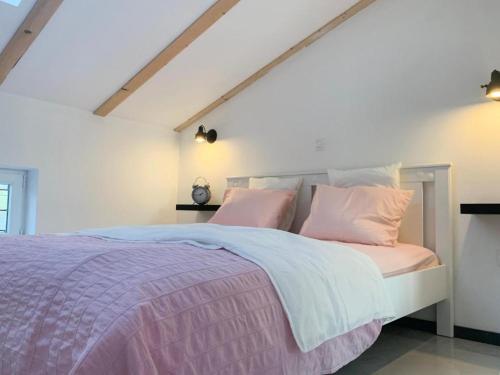 a bedroom with a bed with pink and white pillows at SUNADOR - Adults Only in Crikvenica