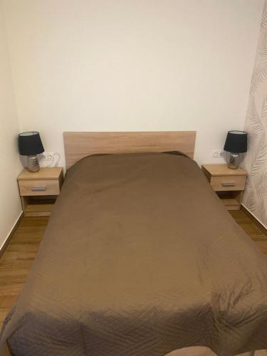 a bedroom with a large bed with two night stands at Beugró Lak in Esztergom