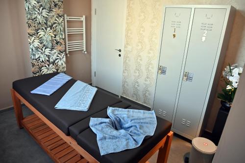 a small room with a bed and two lockers at Safir Hotels Silivri in Silivri