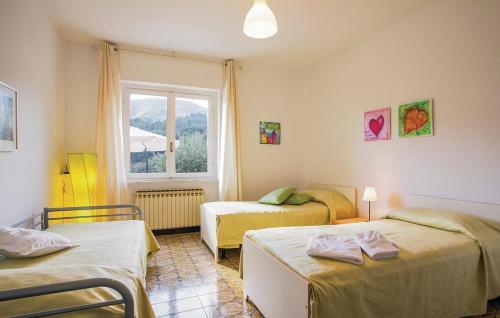 a bedroom with two beds and a window at La Quiete in Casarza Ligure