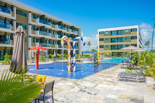 a swimming pool in front of a hotel at Mana Beach Experience By Mai in Porto De Galinhas