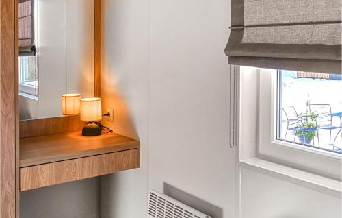 a lamp on a wooden shelf next to a window at Wildkraeuterweg 7 in Untergriesbach