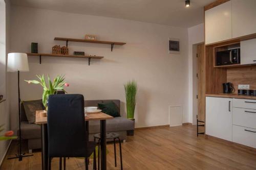 a living room with a table and a couch at Place4You in Ostróda