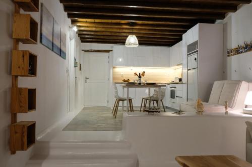 a kitchen and living room with a table and chairs at Our Beautiful House in Ornos, Mykonos in Ornos