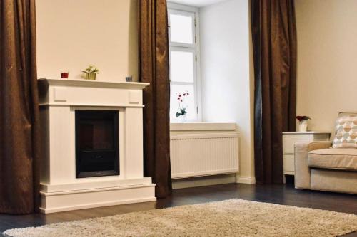 a living room with a fireplace and a window at Scarbantia Casa in Sopron