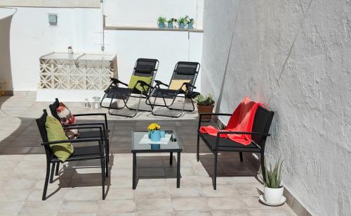 a dog sitting in a chair on a patio at Céntrico apartamento con terraza y WIFI in Ronda