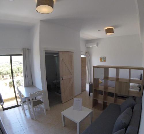 a living room with a couch and a table at The Olive Garden Apartments in Gouves