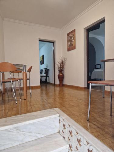 a living room with a table and a dining room at Residencial Antonio Mocisso Guesthouse in Elvas