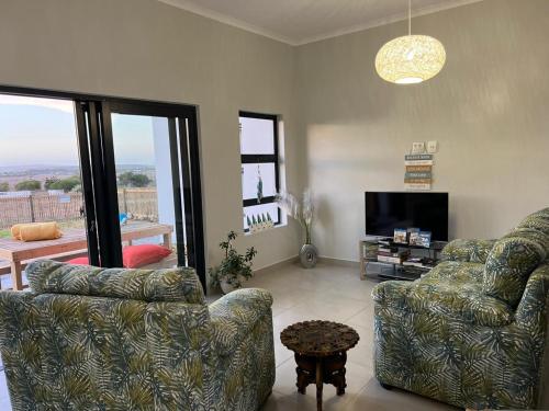 a living room with two couches and a television at Casa Felice in Langebaan