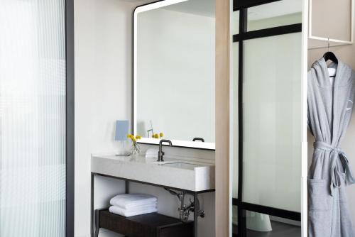 a bathroom with a sink and a mirror at Hyatt Centric Congress Avenue Austin in Austin