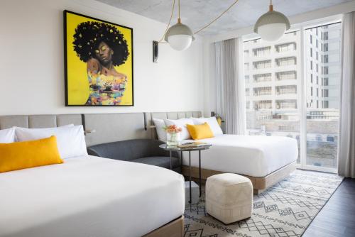 a hotel room with two beds and a table at Hyatt Centric Congress Avenue Austin in Austin