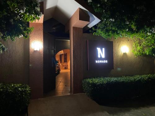 a sign that says n on the side of a building at Nomads in Lomé
