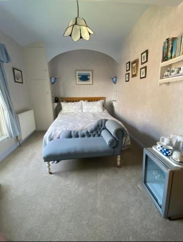 a bedroom with a large bed and a table at Killerby Cottage Farm in Scarborough