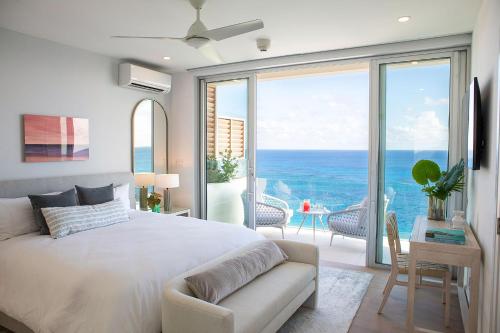 a bedroom with a bed and a view of the ocean at Azura Bermuda in Bermuda