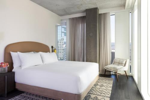 a bedroom with a large white bed and a window at Hyatt Centric Congress Avenue Austin in Austin